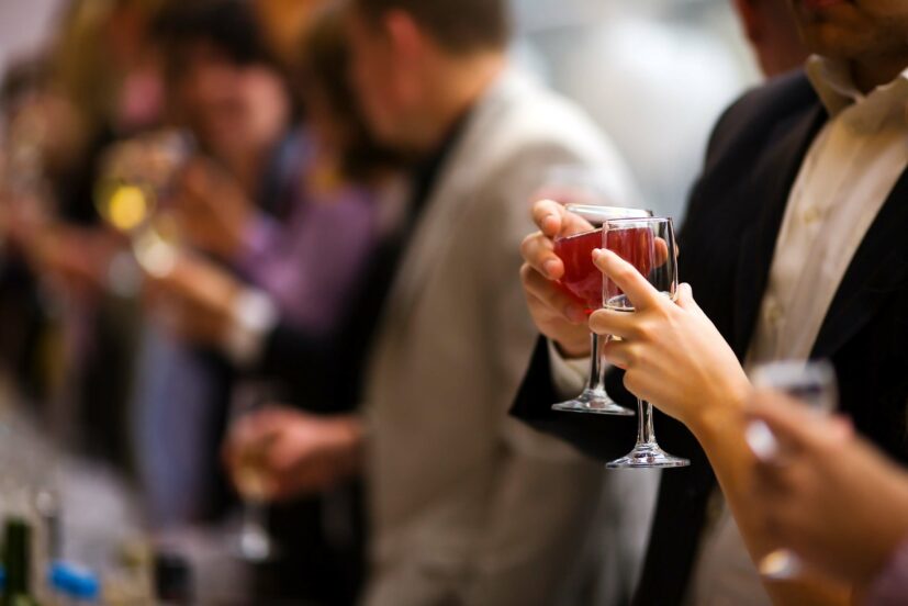 Holiday Event people cheering each other with champagne and wine