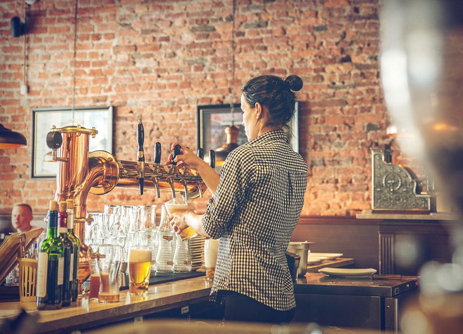 A bartender pouring beers in a venue